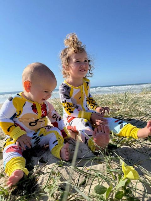 Pebbles Onesie with sunny dandelion trim