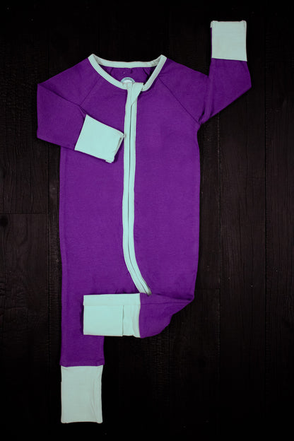 solid purple long sleeve baby onesie with teal trim with fold over hand & foot cuffs and double zip